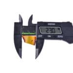 Digital caliper measuring a thin, golden-colored strip with a clear 23.0 mm reading.