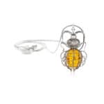 Elegant silver pendant featuring a fiery yellow amber encased in intricate filigree design.