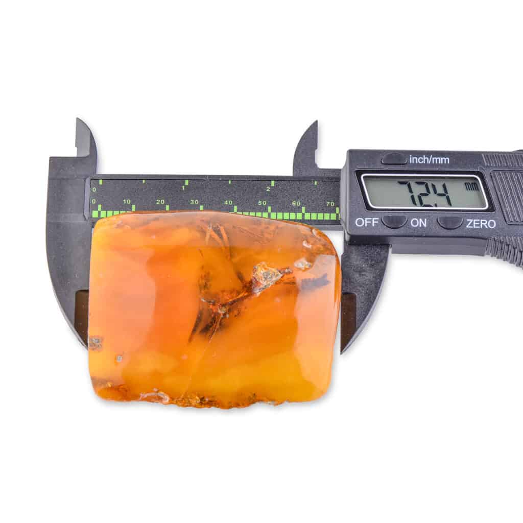 Large natural Baltic amber pendant measuring 72.4mm, showcasing warm color and unique inclusions.