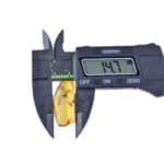 Digital caliper measuring amber gemstone, displaying a 14.7mm width in precise detail.
