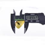 Digital caliper measuring a golden-yellow amber piece with a 2.77mm reading.