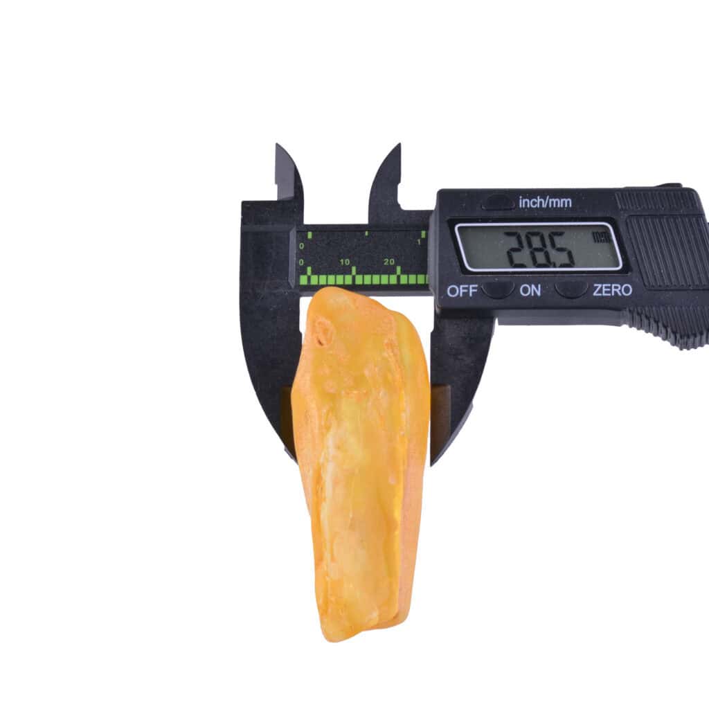 Measuring a mineral specimen with a digital caliper showing 28.5mm in precision accuracy.