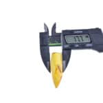 Digital caliper measuring an orange-yellow object resembling a tooth or similar specimen.