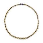 Handcrafted Baltic amber necklace with golden and dark beads for versatile elegance.