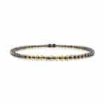 Elegant dark iridescent beaded necklace with symmetrical craftsmanship and timeless style.