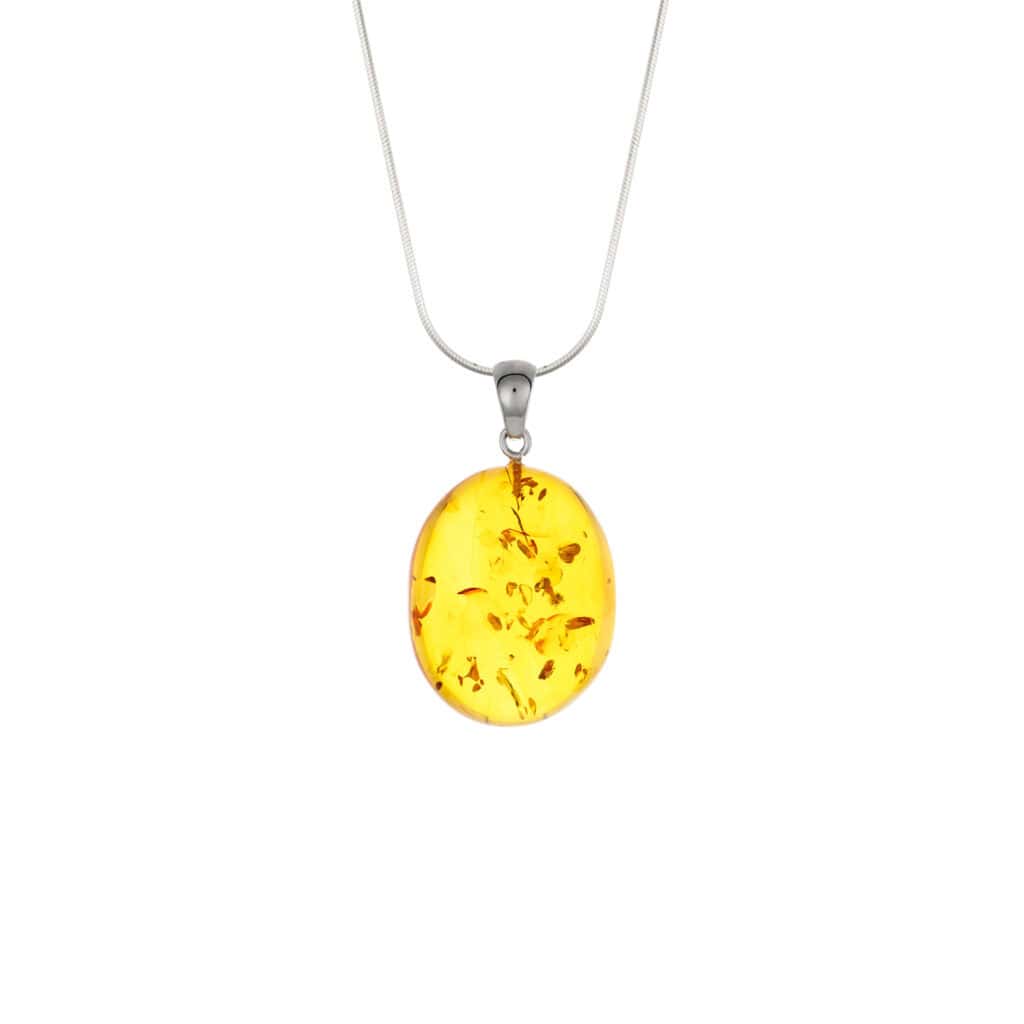 Golden amber pendant with natural inclusions on delicate silver chain, timeless and elegant jewelry piece.