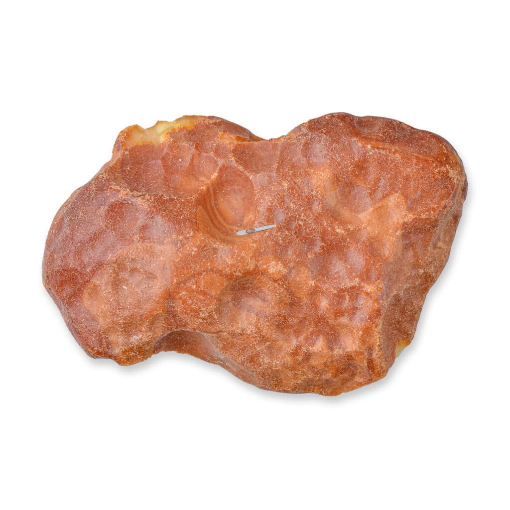 Natural peach-orange quartz-like mineral with organic shape, translucent areas, and earthy textures.