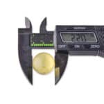Digital caliper measuring a glossy yellow sphere, displaying 22.7 mm for precise dimension.