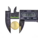 Digital caliper measuring 22mm yellow amber gemstone for jewelry and precision applications.