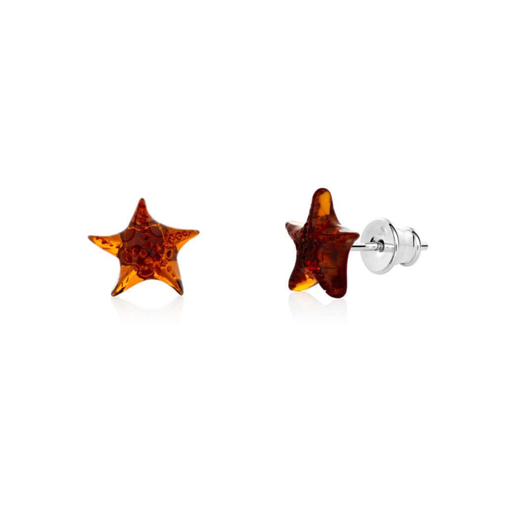 Star-shaped amber earrings with silver posts, handcrafted, glossy, and versatile for any occasion.