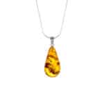 Teardrop Baltic amber necklace with silver chain and natural inclusions, elegant and timeless.