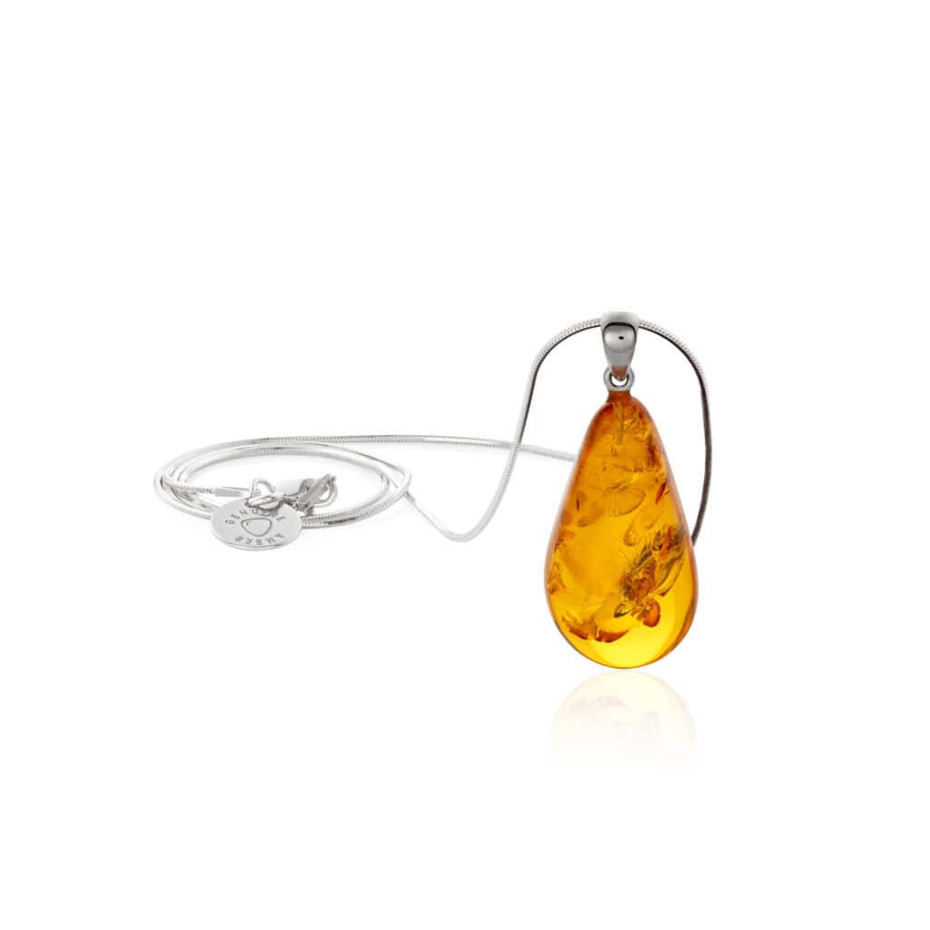 Handcrafted amber pendant with silver chain, featuring warm tones and natural inclusions.