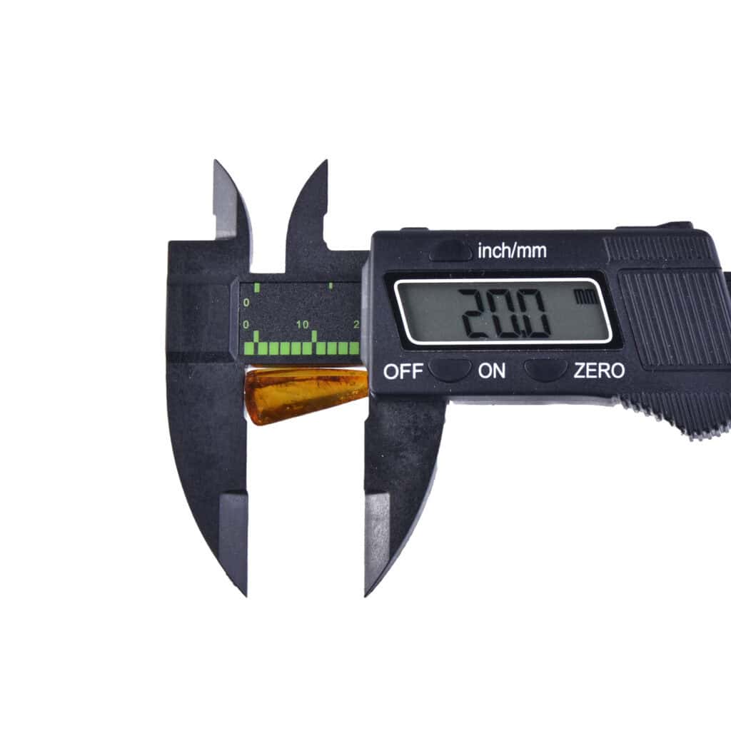 Digital caliper measuring a small object with a reading of 2.00 units in precise detail.