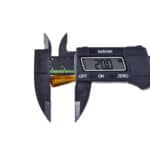 Digital caliper measuring a small object with a reading of 2.00 units in precise detail.