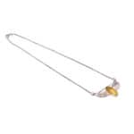 Yellow gemstone necklace with delicate silver wing design and sleek chain, perfect for any occasion.