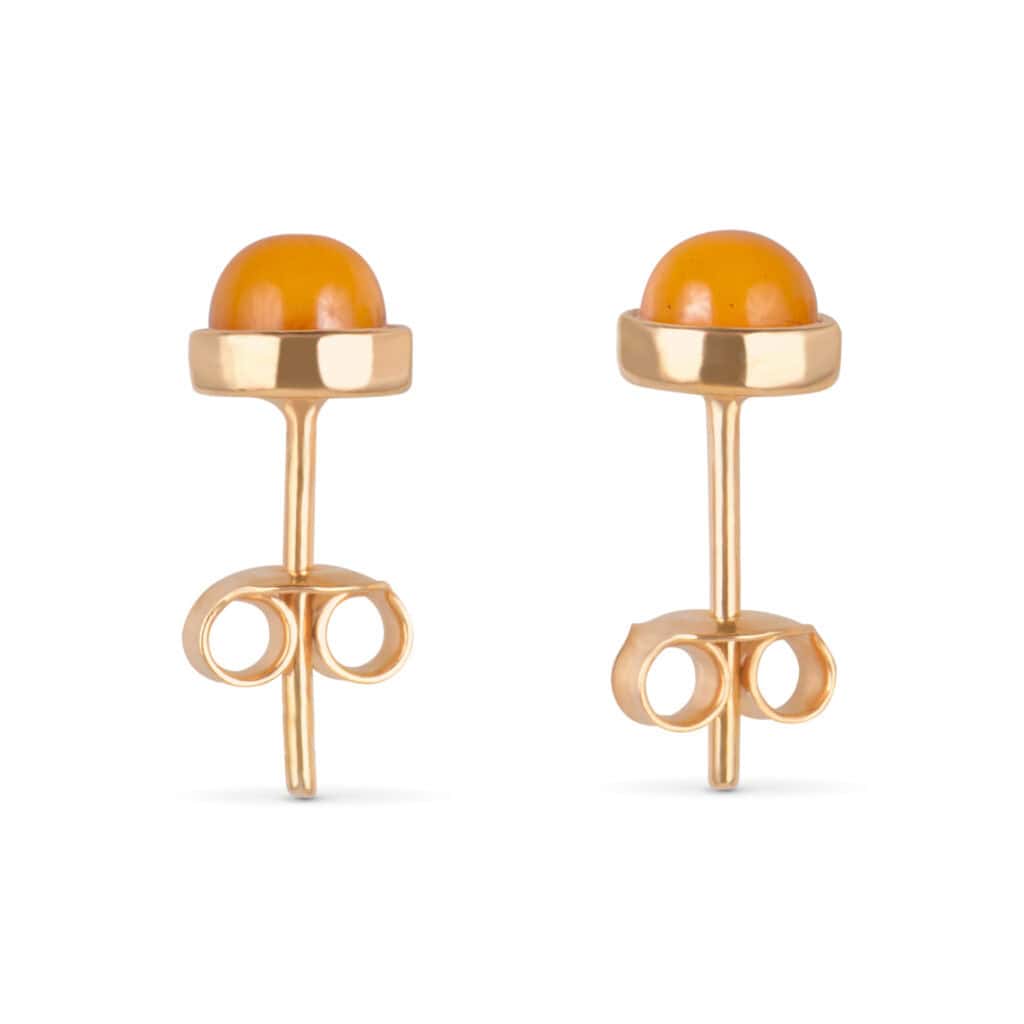 Elegant gold stud earrings with vibrant orange stones and artistic looping accents.