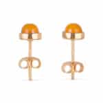 Elegant gold stud earrings with vibrant orange stones and artistic looping accents.