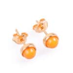Elegant orange Baltic amber stud earrings with gold accents, perfect for daily or special occasions.