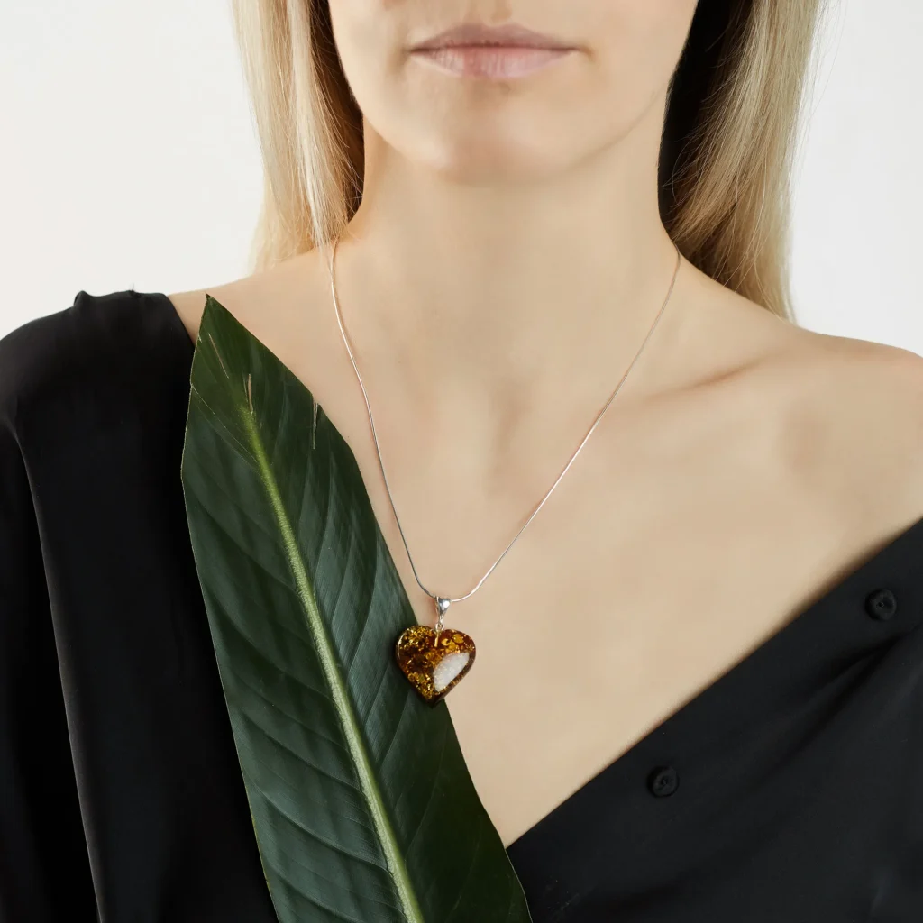 Elegant cognac Baltic amber heart necklace with silver chain, showcasing natural warmth and timeless beauty.