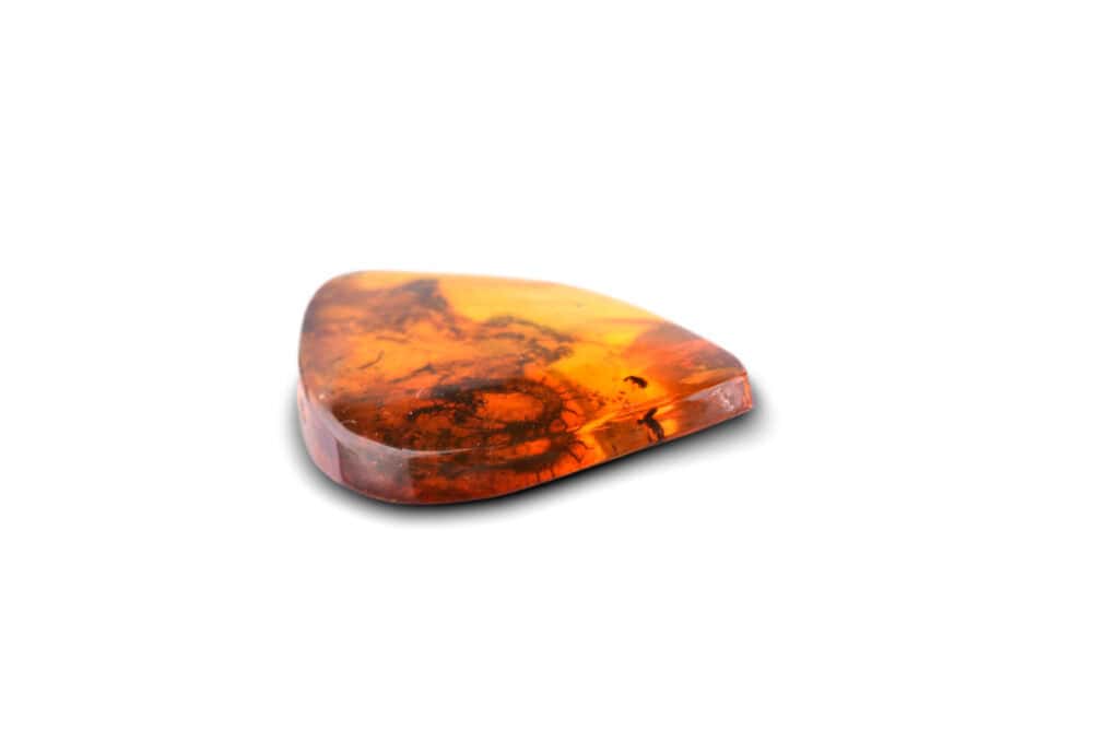 Polished amber gemstone with natural inclusions, warm orange tones, and organic, unique textures.