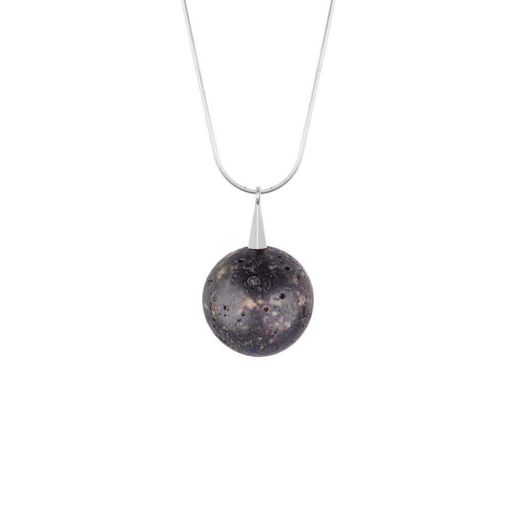 Earthy black volcanic pendant with sterling silver chain, versatile and handcrafted for everyday elegance.