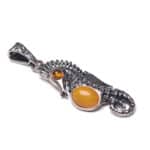 Elegant silver seahorse pendant with Baltic amber accents, handcrafted jewelry for nature lovers.