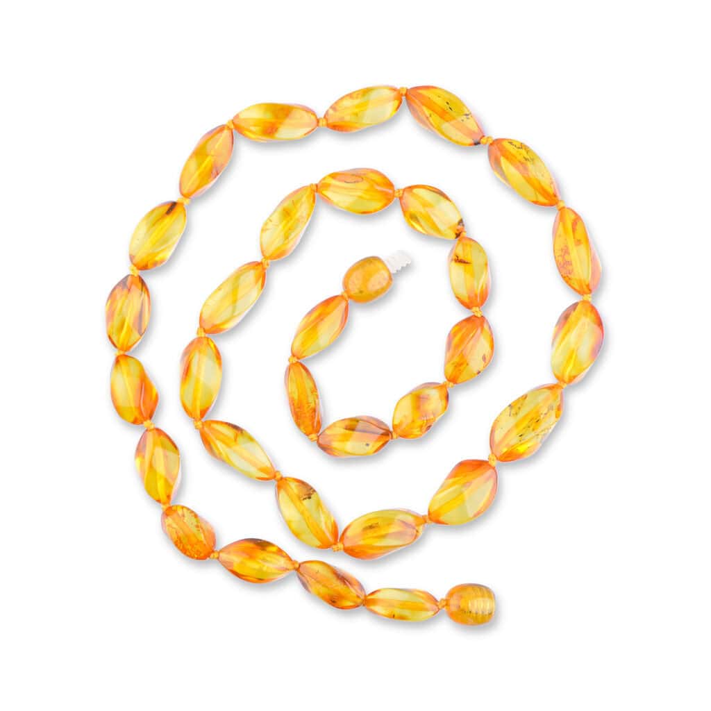 Spiral arrangement of vibrant yellow-orange translucent beads forming a stunning, handcrafted jewelry piece.