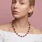 Blonde woman with cognac amber and rose quartz necklace