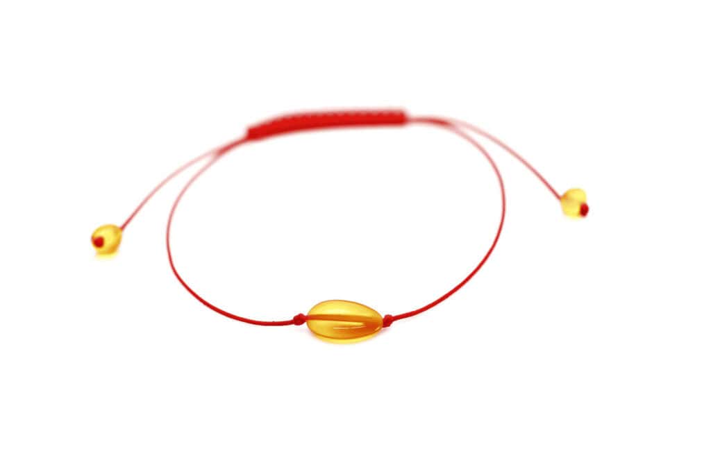 natural amber with red string